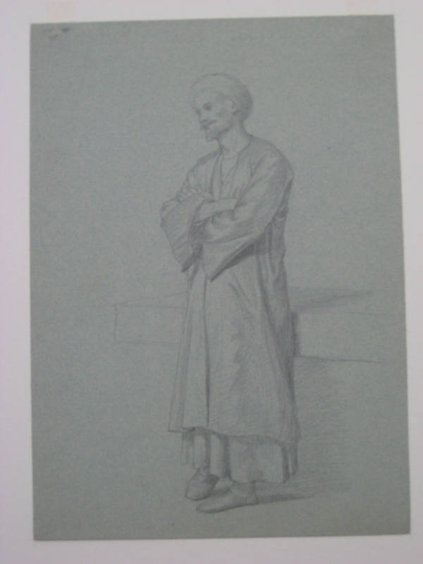 Untitled - A man in a robe and turban, standing with arms folded