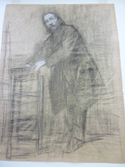 Study of standing male reaching into box on chair